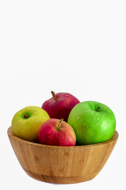 istock Red, pink, yellow and green apples in a bamboo bowl 1031624214