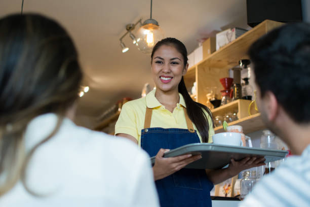 istock Waitress serving a couple at a bakery 1031625514
