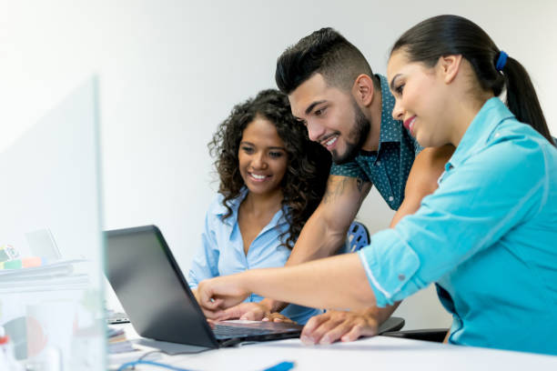 istock Business group at the office looking at something on the laptop screen and smiling 1031629146