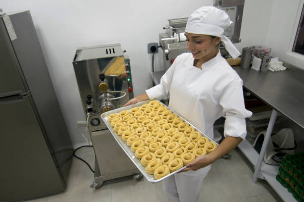 istock Beautiful cook making pasta at a factory 1031629348