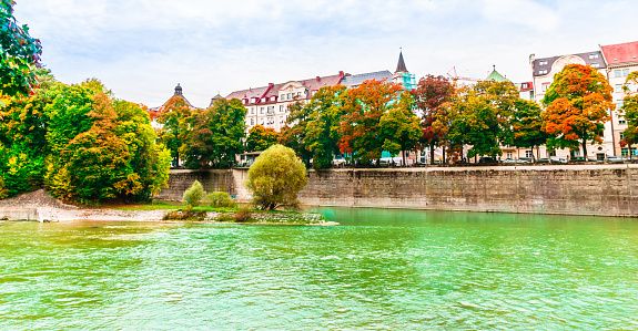 View on colorful autumn landscape of Isar river in Munich, Bavaria - Germany