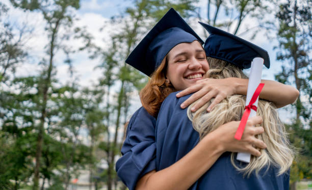 istock High school friends celebrating they graduated hugging and smiling 1031634914