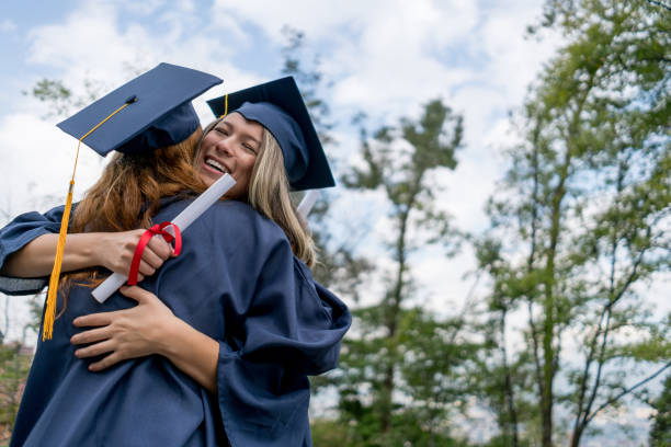 istock Beautiful friends hugging excited because they just graduated 1031634920