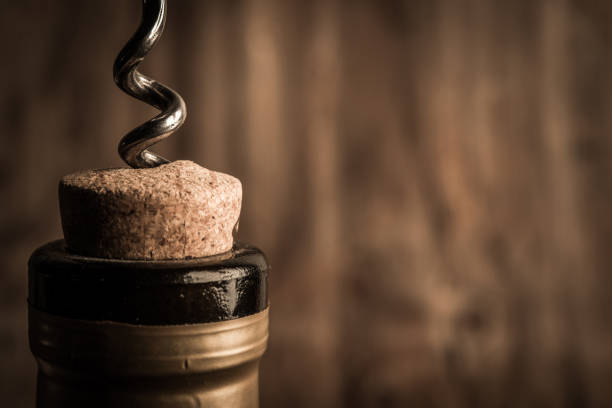 istock Bottle of wine with corkscrew on wooden background 1031647050