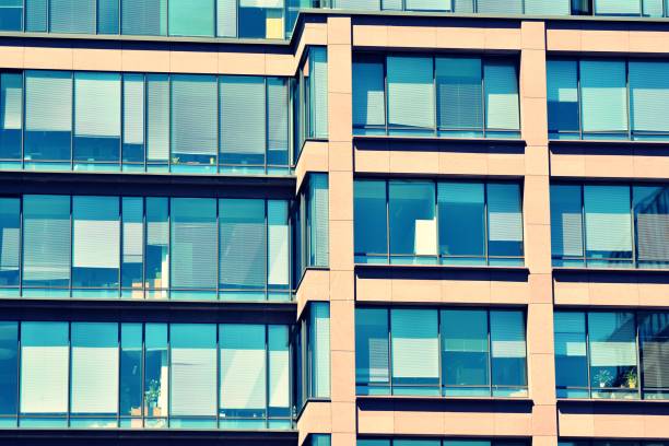 istock Modern office building on a clear sky background. Retro stylized colorful tonal filter effect 1031650144