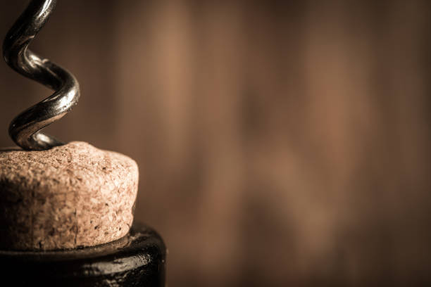 istock Steel corkscrew opens a bottle of wine closeup 1031650426
