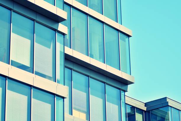 istock Modern office building on a clear sky background. Retro stylized colorful tonal filter effect 1031656506