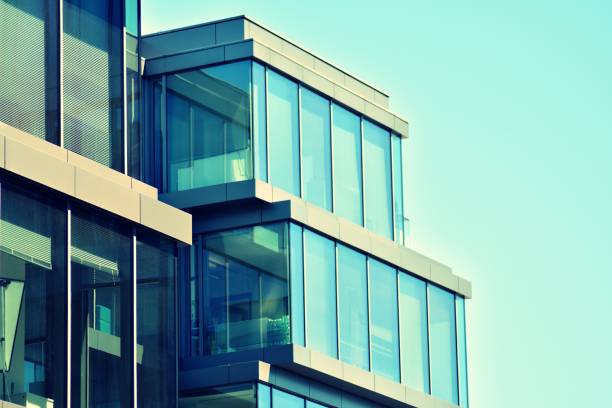 istock Modern office building on a clear sky background. Retro stylized colorful tonal filter effect 1031659126