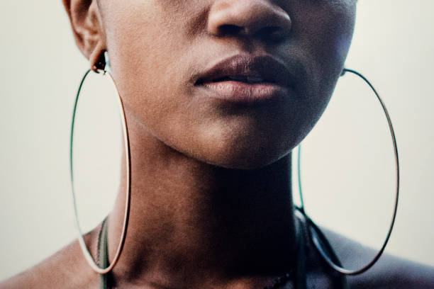 Close Up Portrait of Young Womans Face A portrait of the face of a young African American woman. hoop earring stock pictures, royalty-free photos & images