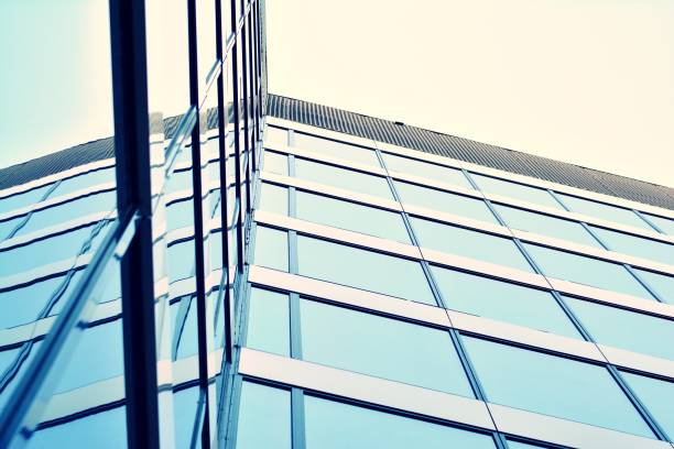 istock Modern office building on a clear sky background. Retro stylized colorful tonal filter effect 1031660012