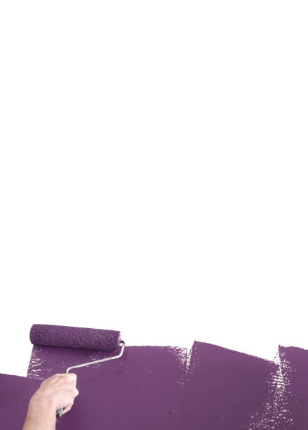 istock Person Painting a Wall Purple with a Paint Roller 1031662388