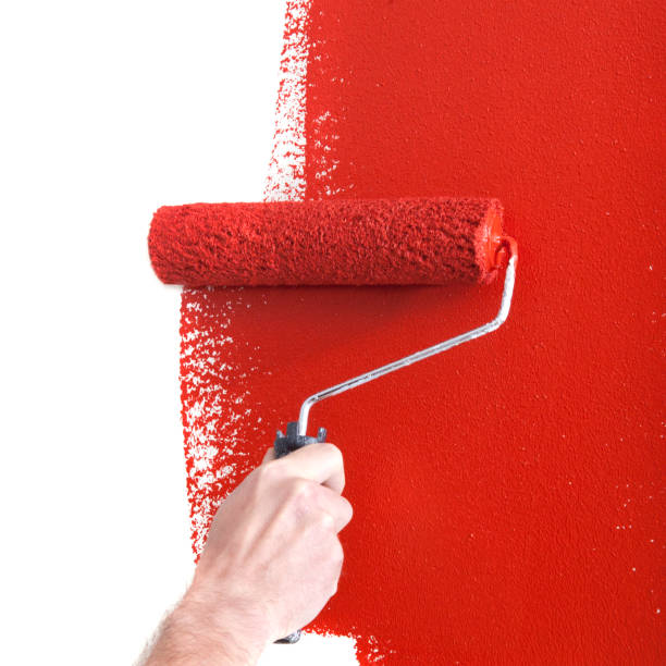 istock Person Painting a Wall Red with a Paint Roller 1031662442