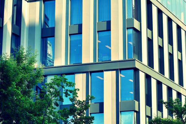 istock Modern office building on a clear sky background. Retro stylized colorful tonal filter effect 1031662464