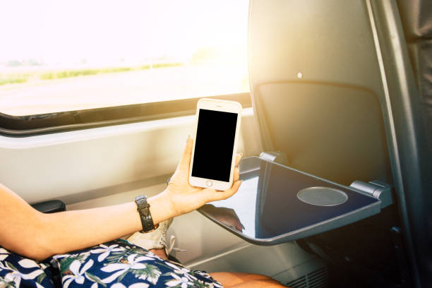 istock Woman Using Smart Phone with black screen in Train 1031663090