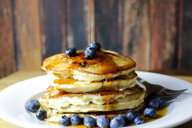 Stack of Blueberry Pancakes with Maple Syrup A stack of homemade blueberry pancakes with fresh blueberries and Maine maple syrup pancake photos stock pictures, royalty-free photos & images