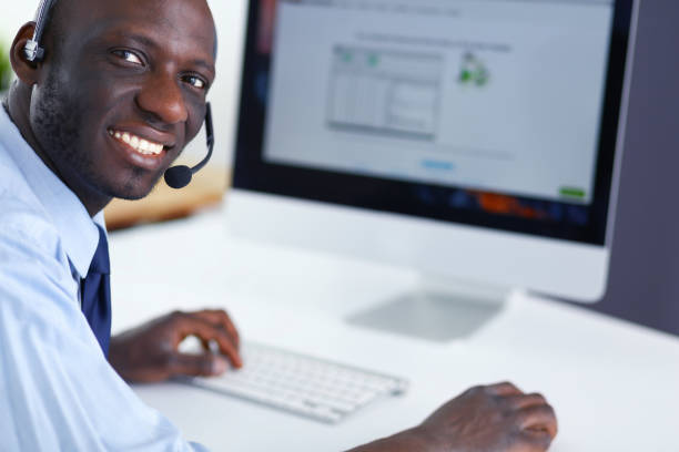 istock African american businessman on headset working on his laptop 1031663650