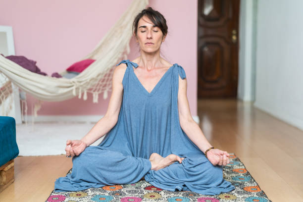 istock Mature Woman Practicing Yoga At Home 1031692602