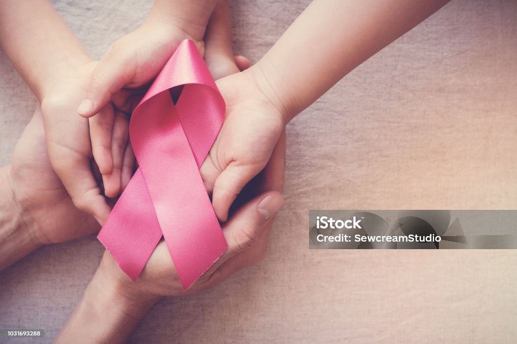 hands holding pink ribbon, breast cancer awareness, October pink concept Cancer - Illness Stock Photo