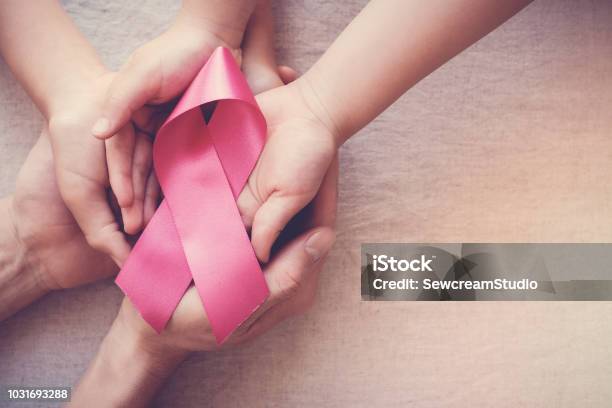 Hands Holding Pink Ribbon Breast Cancer Awareness October Pink Concept Stock Photo - Download Image Now