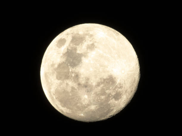 Moon in the middle of its way on the clear sky