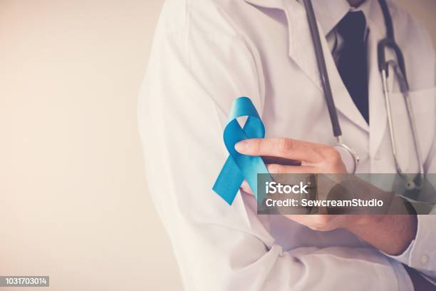 Doctor Hands Holding Light Blue Ribbon Prostate Cancer Awareness Stock Photo - Download Image Now