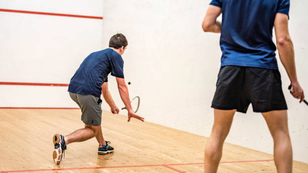 istock Male squash player caught at the moment before hitting the ball 1031705702