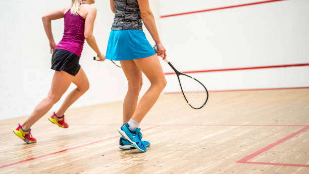 istock Two unrecognisable female squash player running on the court 1031705718