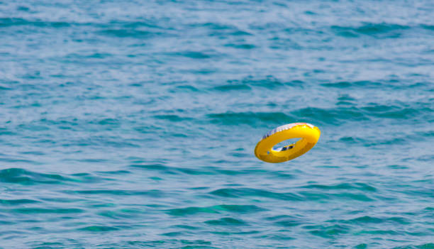 istock yellow life buoy flying on the sea 1031725100