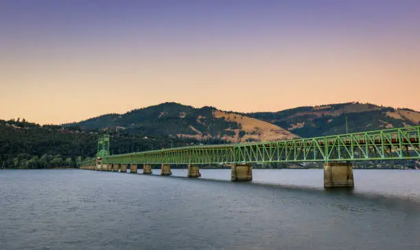 The green truss Hood River Bridge that crosses the Columbia River Gorge and connects Hood River in Oregon