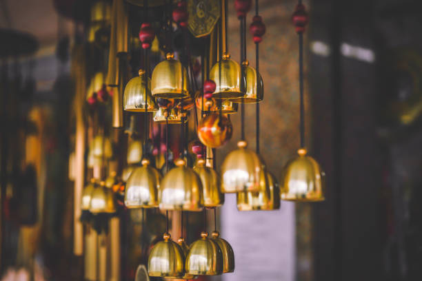 Row of brass bells wind chimes at Wat Songkhram, Bangkok, Thailand