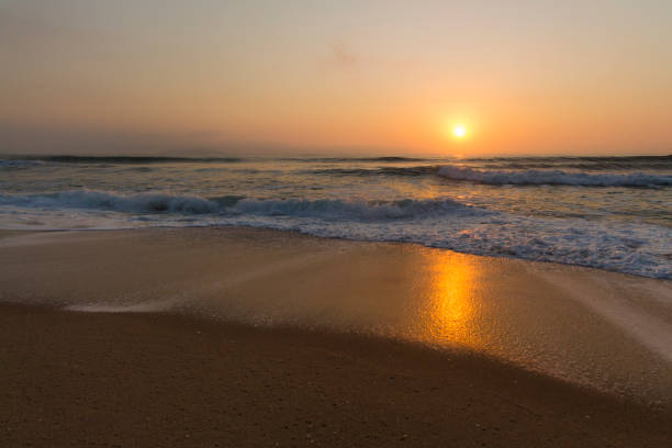 istock A warm sunrise on the beach 1031737026