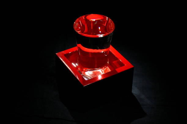 istock Lacquered red container, masu, and glass for drinking or measuring sake on black background 1031737200