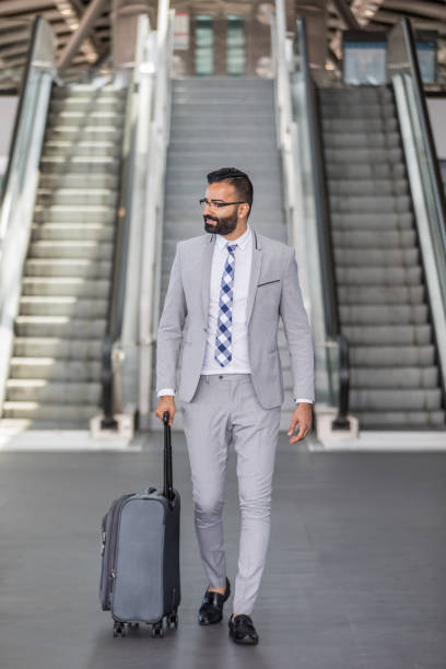 istock Businessman Using Cell Phone at an Airport 1031742352