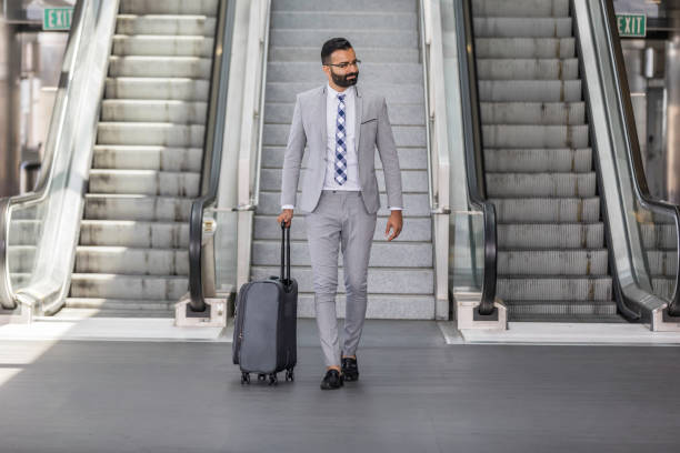 istock Businessman Using Cell Phone at an Airport 1031742388