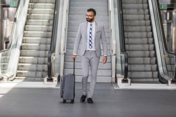 istock Businessman Using Cell Phone at an Airport 1031742406