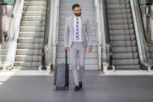 istock Businessman Using Cell Phone at an Airport 1031742410