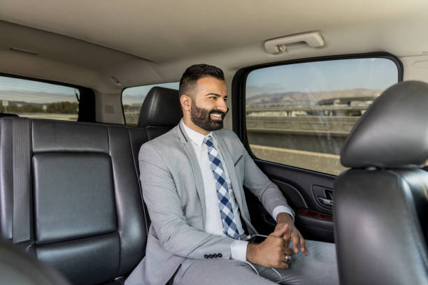 istock Businessman Using Smart Phone in a Limousine 1031746880