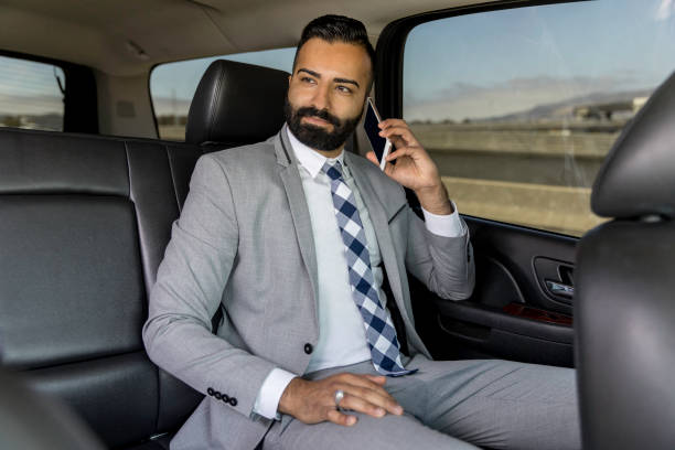 istock Businessman Using Smart Phone in a Limousine 1031746898