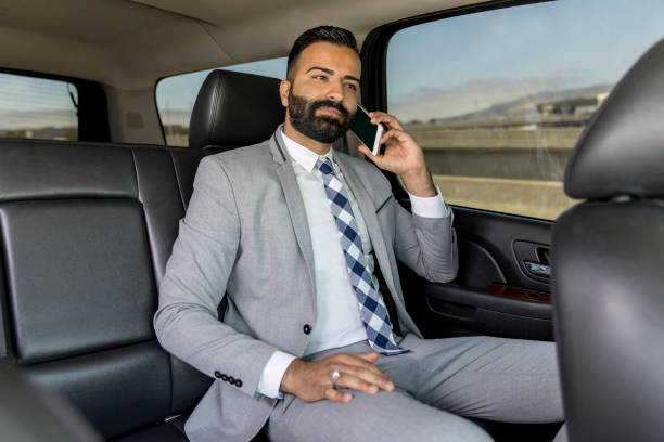 istock Businessman Using Smart Phone in a Limousine 1031746928