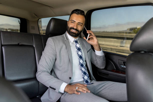 istock Businessman Using Smart Phone in a Limousine 1031747008