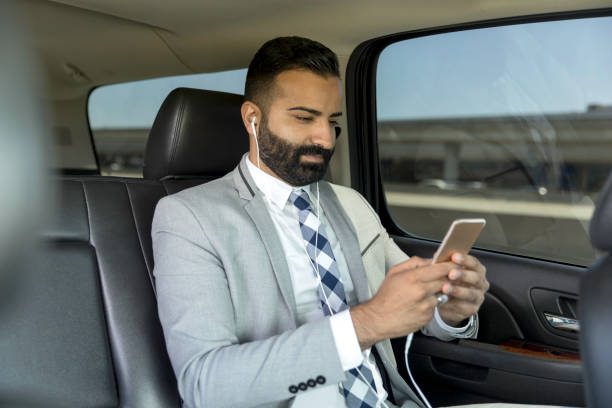 istock Businessman Using Smart Phone in a Limousine 1031747014