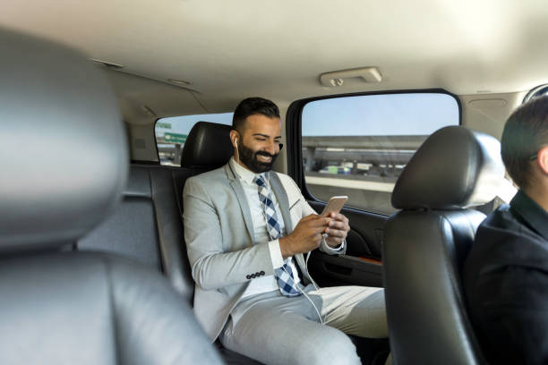 istock Businessman Using Smart Phone in a Limousine 1031747074