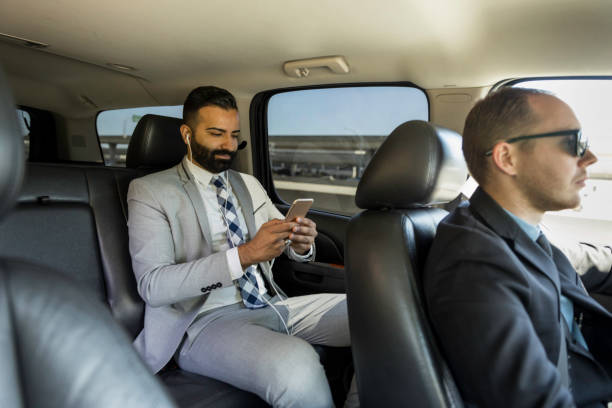 istock Businessman Using Smart Phone in a Limousine 1031747154