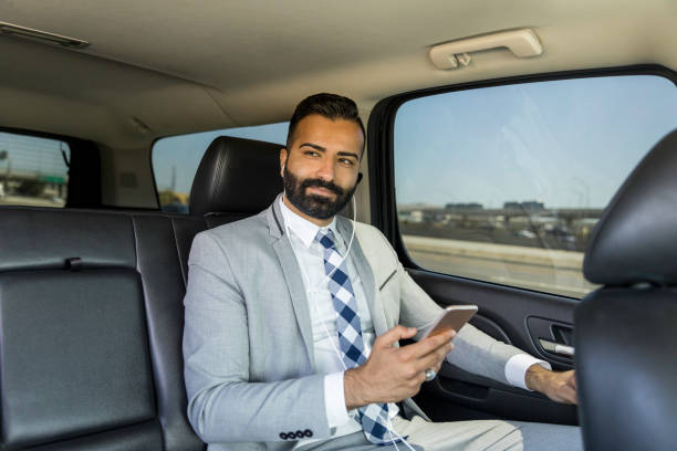 istock Businessman Using Smart Phone in a Limousine 1031747228