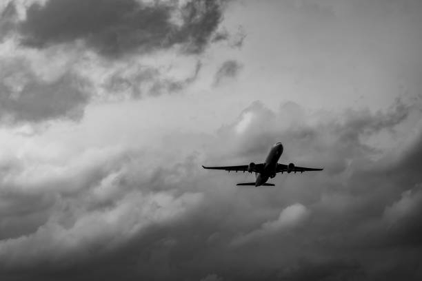 istock Commercial airplane on grey sky and clouds with copy space. Failed vacation. Hopeless and despair concept. Moody sky and transport plane. Sad emotional scene. Background of aircraft flight. 1031747320