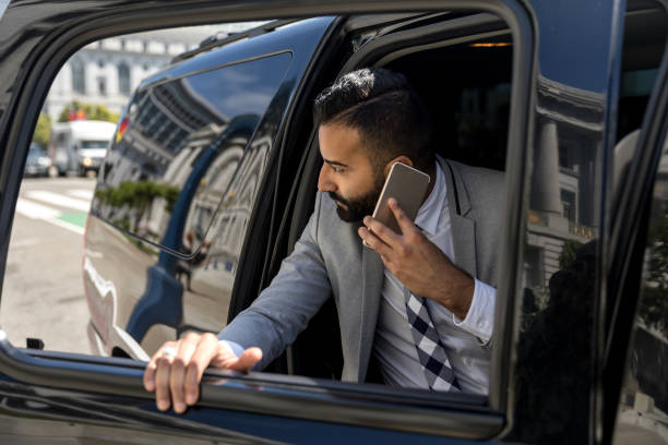 istock Businessman Using Smart Phone in a Limousine 1031759798