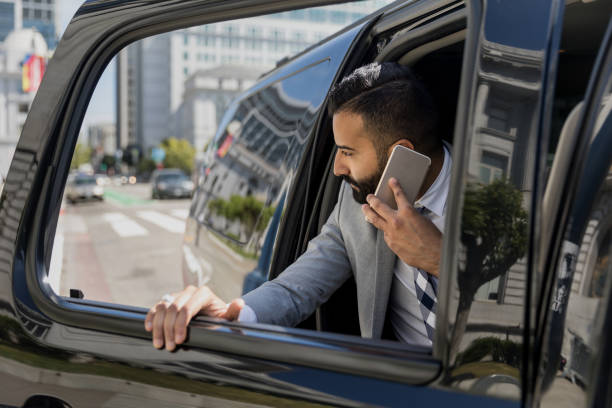 istock Businessman Using Smart Phone in a Limousine 1031759846