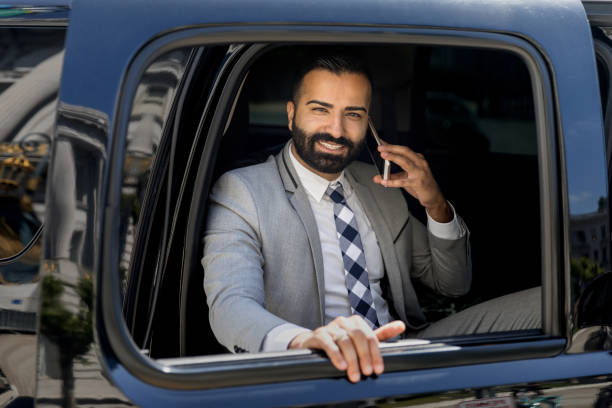 istock Businessman Using Smart Phone in a Limousine 1031759922
