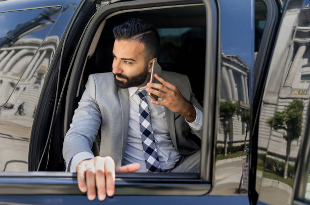 Businessman Using Smart Phone in a Limousine