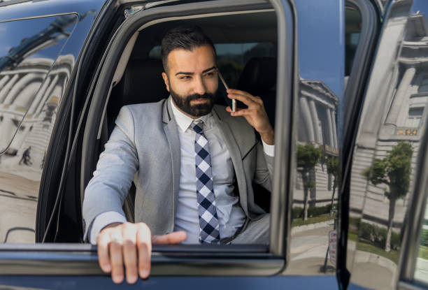 istock Businessman Using Smart Phone in a Limousine 1031759990